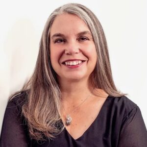 CarlyJFlagg_bio481pix bio headshot photo of white woman with light straight hair looking into camera with white background